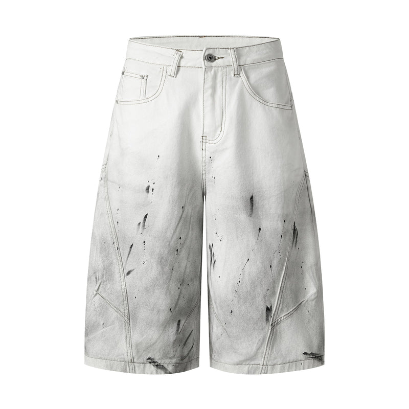 Front view of white wide-leg denim shorts with black distressed splatter and contrast stitching