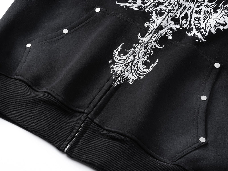 Close-up of black hoodie front pocket, zipper, and white cross print detail