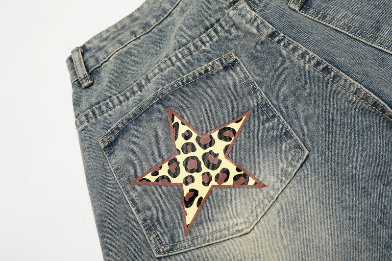 Close-up of back pocket star patch on faded blue denim jeans