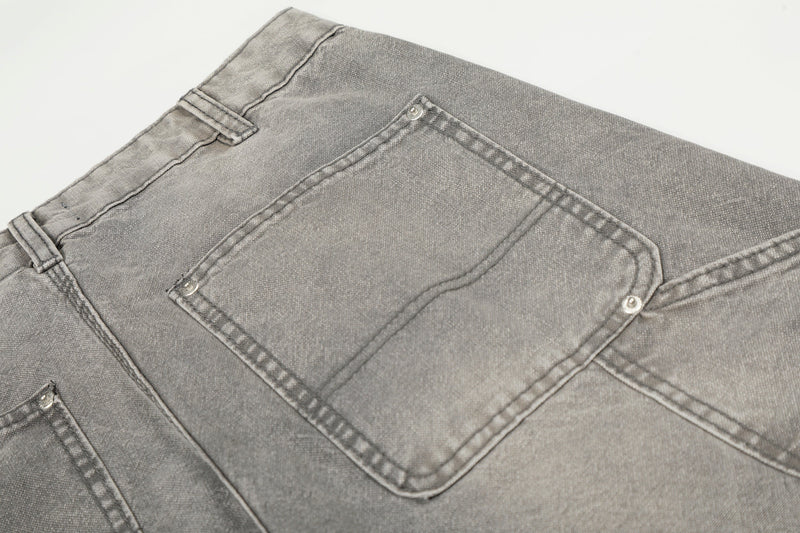 Close-up of gray carpenter jeans back pocket with stitched panel detail