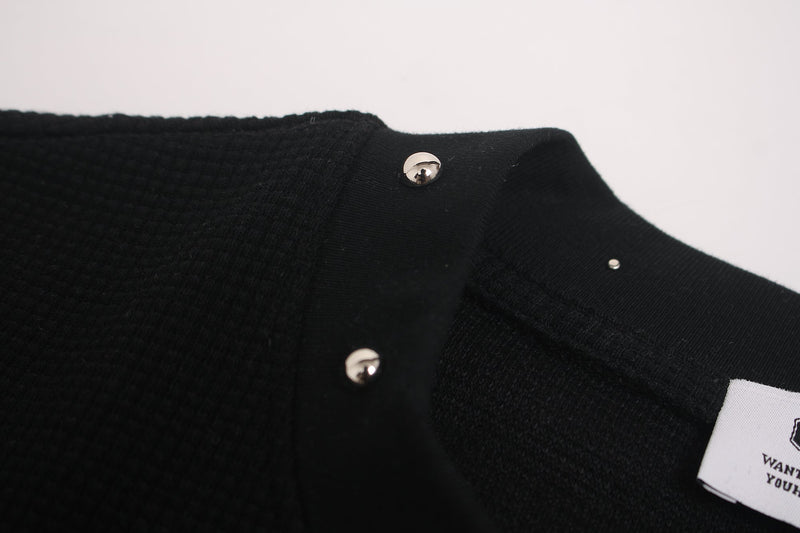 Black studded mock-neck graphic tee with close-up shoulder detail and visible clothing tag