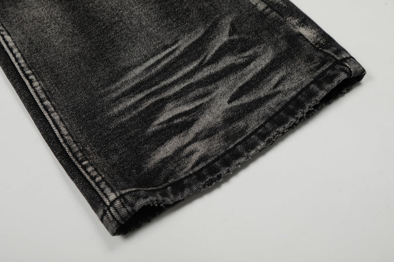 Close-up of the jeans cuff hem on black washed denim