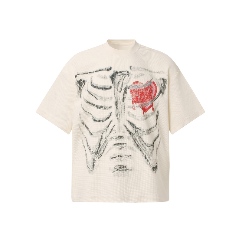 Cream oversized graphic tee with black ribcage print and a dripping red heart on the chest