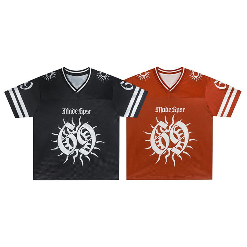 Black and orange graphic football jerseys with solar emblem print, V-neck trim, and striped sleeves on white background