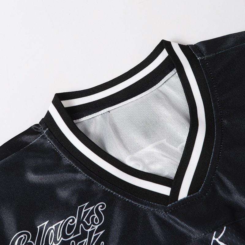 Black mesh football jersey with white striped ribbed collar and spider web graphic detail