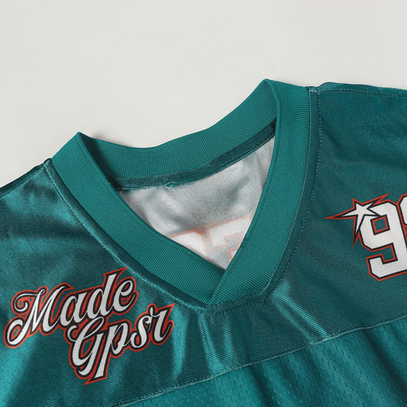 Teal football jersey tee with V-neck, cracked number 98, and Made Ghost graphic on the chest