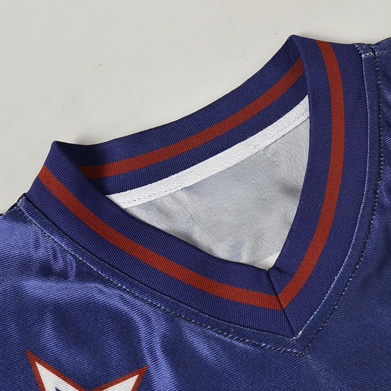 Close-up of a blue football jersey with striped V-neck collar and white star graphic, retro varsity streetwear style