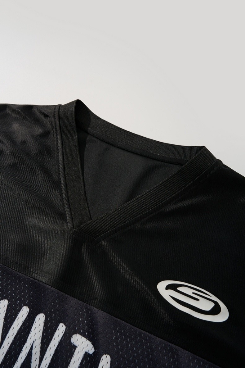 Black mesh football jersey with V-neck, white Seakoff logo, and bold Running 89 graphic detail