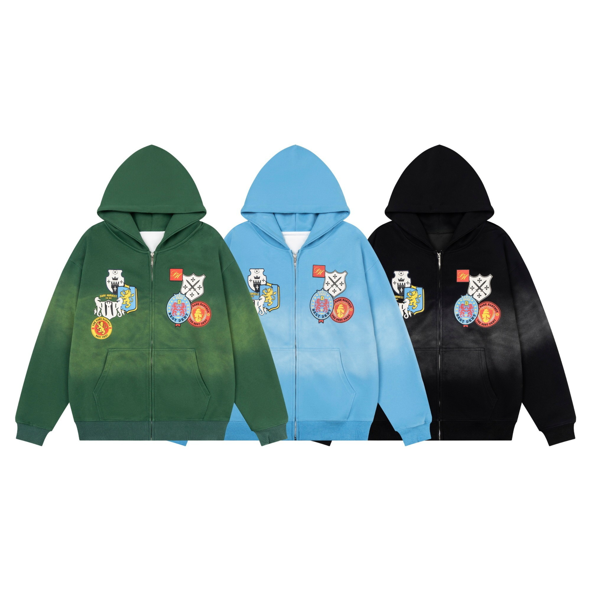 Three crest patch zip-up hoodies displayed side by side in washed green, sky blue, and black with heraldic graphic prints