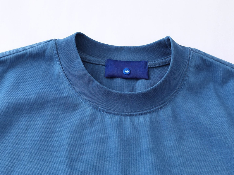 Blue crewneck graphic T-shirt with visible collar, seam details, and size M neck label