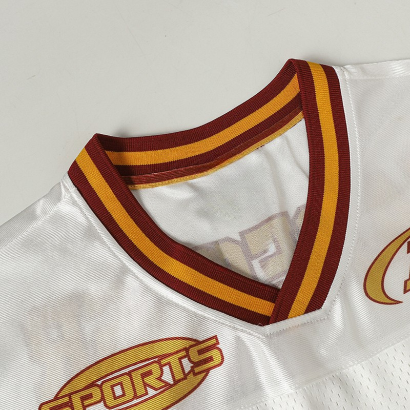 White Seakoff football jersey with maroon and gold striped V-neck collar and Sports logo