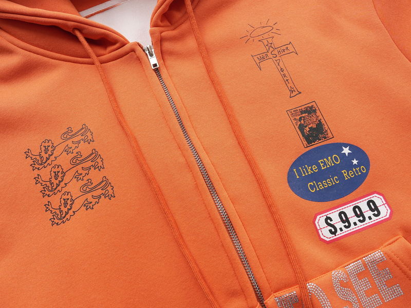Close-up of orange hoodie chest graphics, zipper, and drawstrings