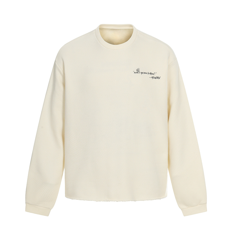 Front view of cream sweatshirt with small black chest text and long sleeves