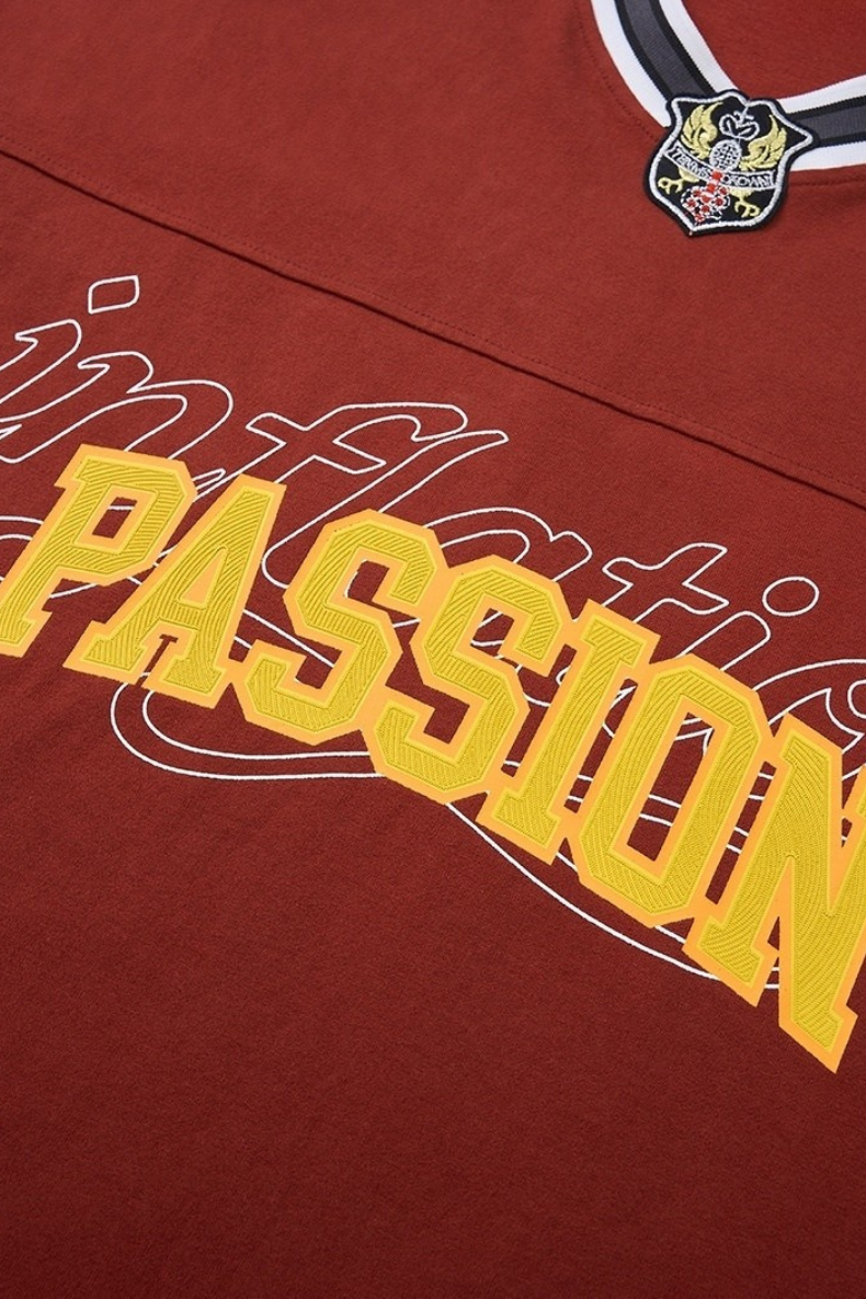 Maroon V-neck tee with varsity-style PASSION graphic and crest patch at the neckline