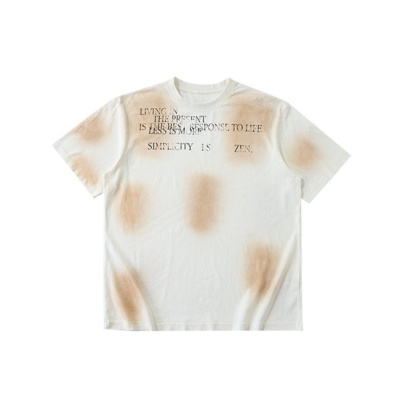 Off-white vintage spray-dyed T-shirt with minimalist text print and beige tie-dye accents on the chest and sleeves