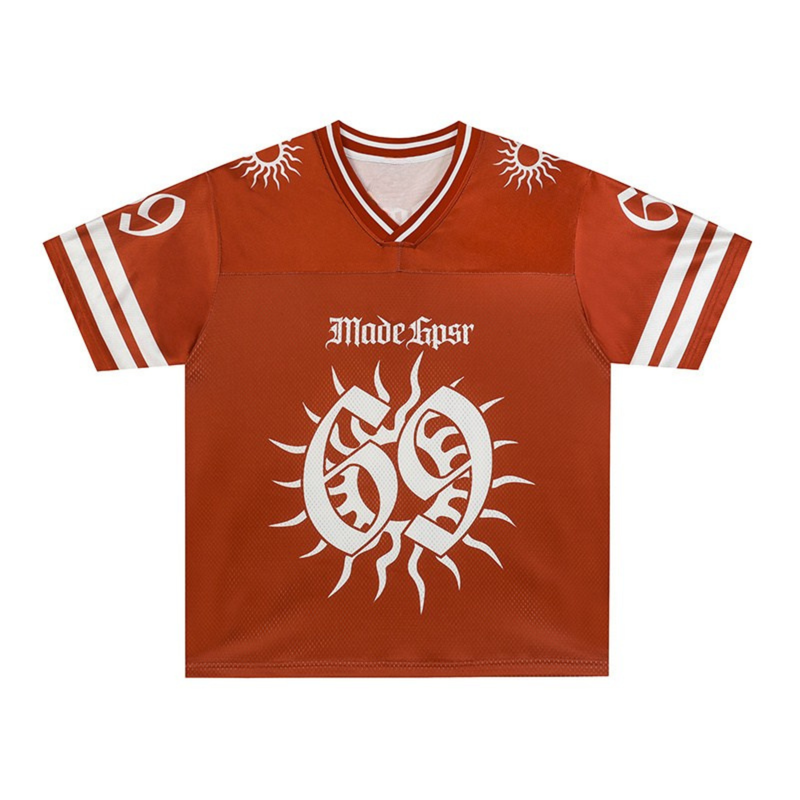 Rust orange football jersey with white sun graphics, striped sleeves, and a bold solar emblem on the chest