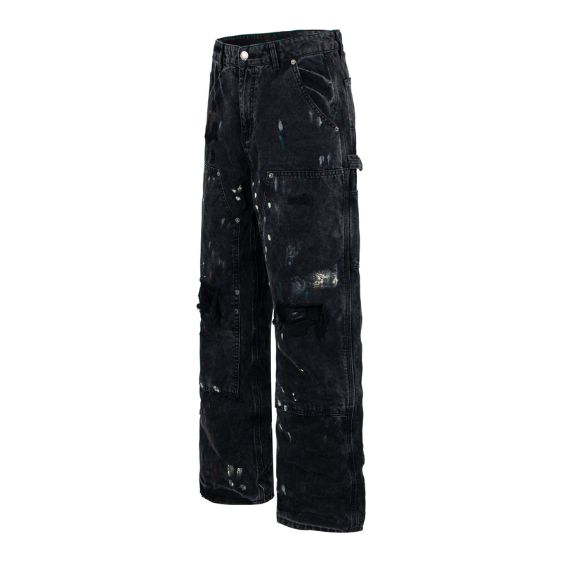 Three-quarter front view of black distressed workwear denim pants with utility pockets