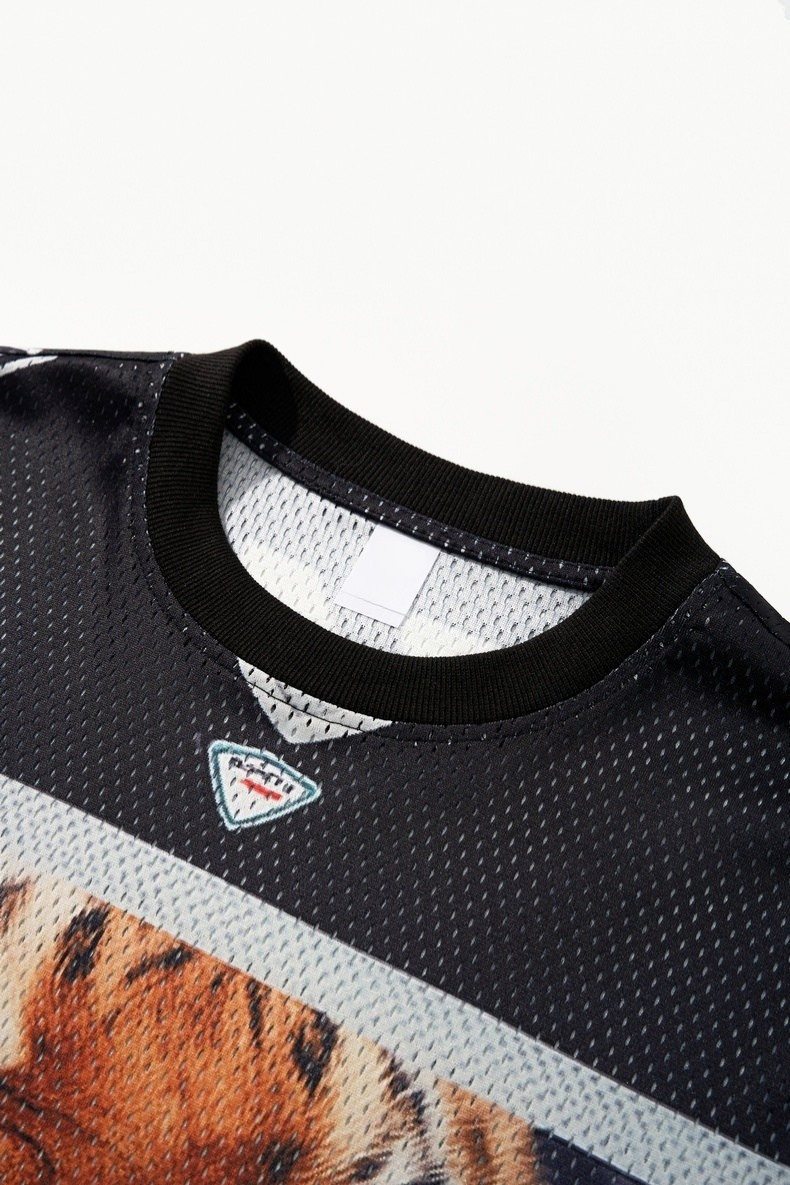 Black mesh jersey with ribbed collar and tiger graphic detail on the chest, styled as a streetwear sport tee