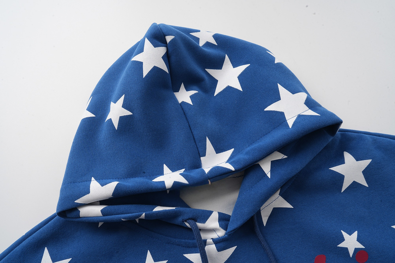 Close-up of blue hoodie hood with white star print and drawstring opening
