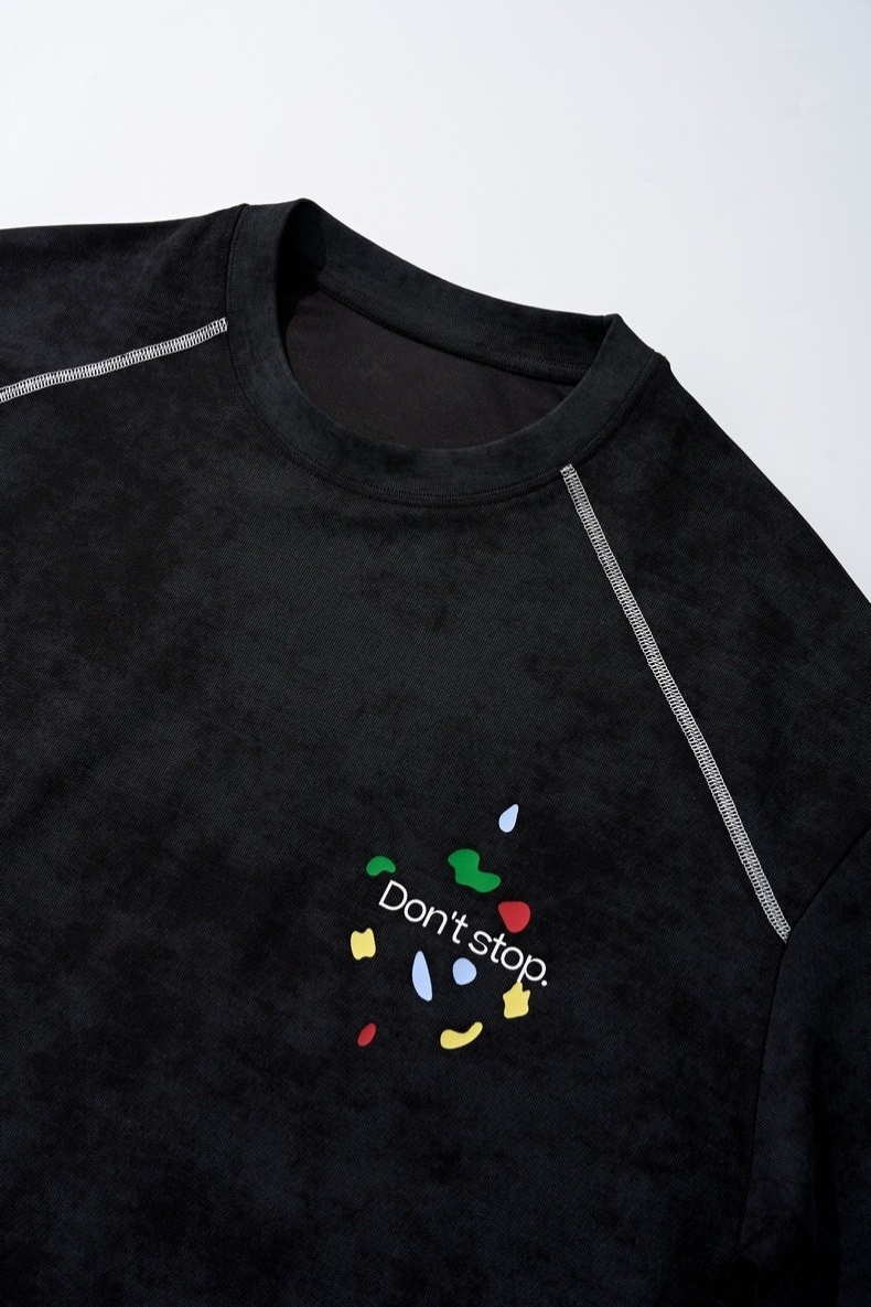 Black vintage wash graphic tee with stitched shoulder seams and a small Don't stop. chest print