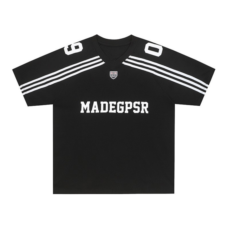 Black football-inspired jersey with white shoulder stripes, V-neck, and bold MADEGPSR logo on the chest