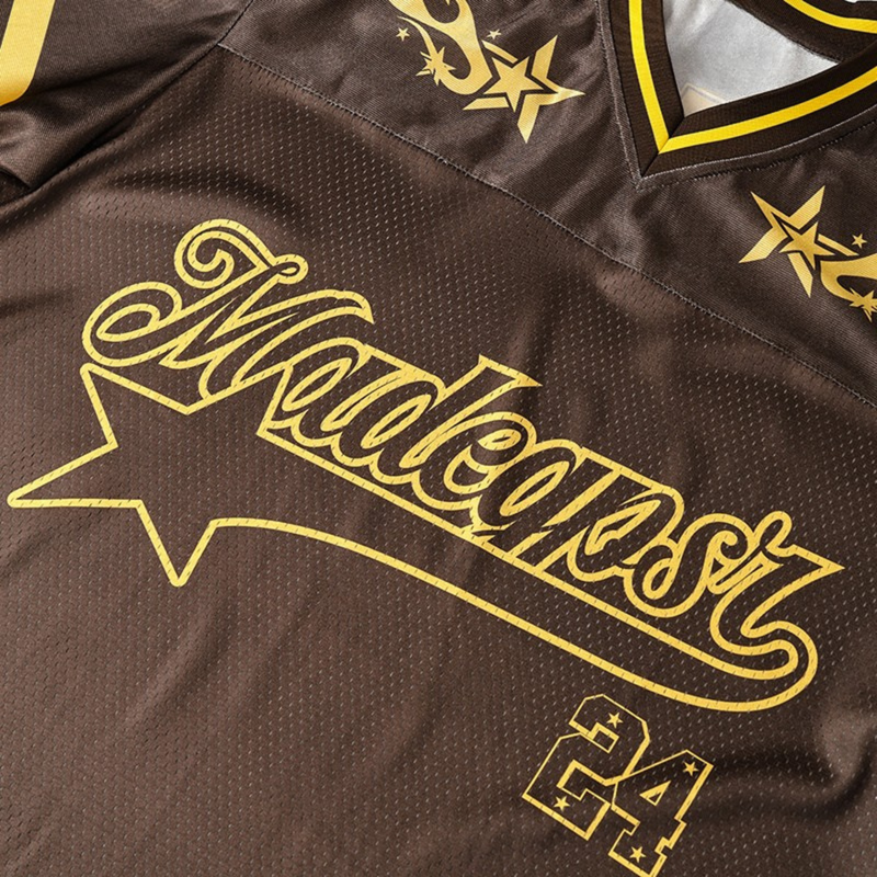 Brown mesh varsity jersey with gold star graphics and large script lettering, featuring a V-neck street football style design