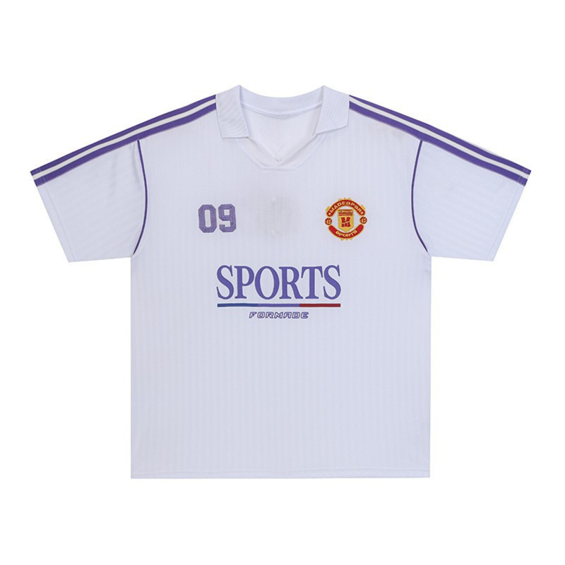 White sports club polo jersey with purple shoulder stripes, number 09, and Manchester-style crest on chest