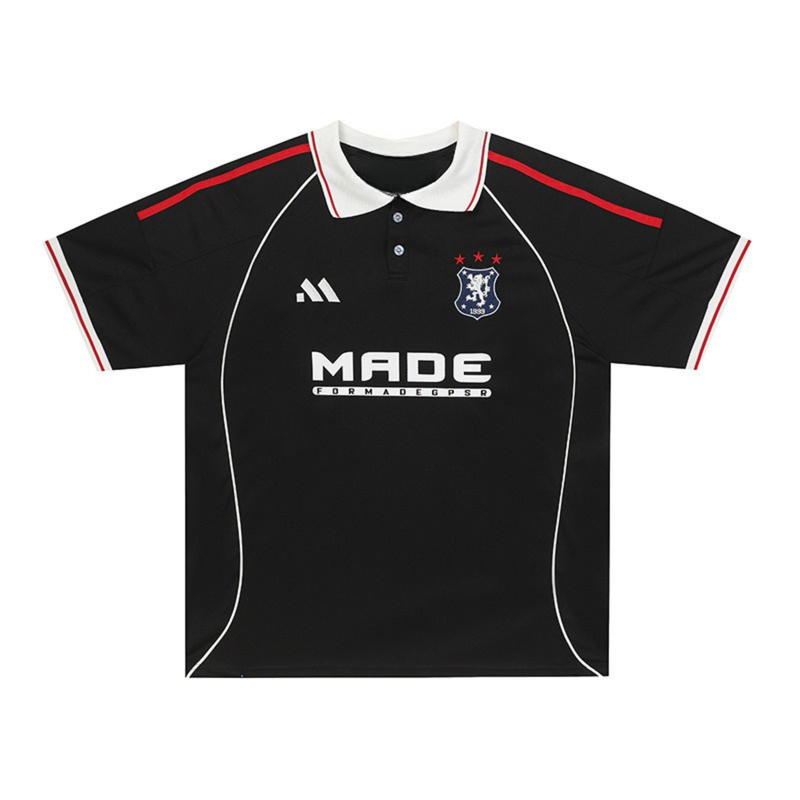 Black football polo jersey with white collar, red trim, club crest, and bold front sponsor logo on a street-sport athletic fit