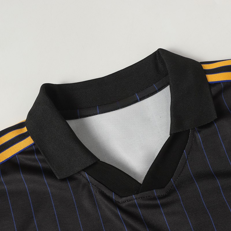 Black pinstripe football jersey with a ribbed collar and yellow striped shoulder accents for a vintage streetwear look