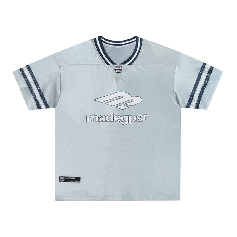 Light blue Madegpsr performance jersey tee with navy striped V-neck and logo print on front