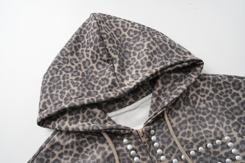 Close-up of leopard print hood and front zipper on the cropped hoodie