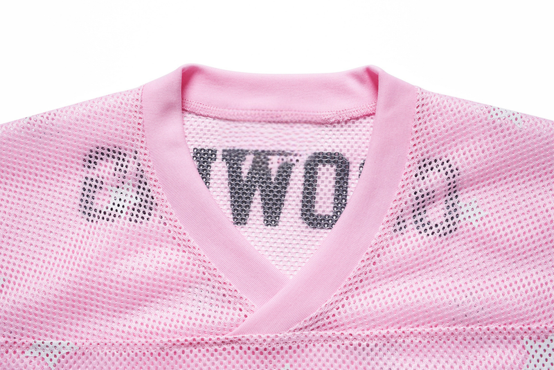 Pink mesh jersey with V-neck trim and oversized black star print details on the shoulders and chest