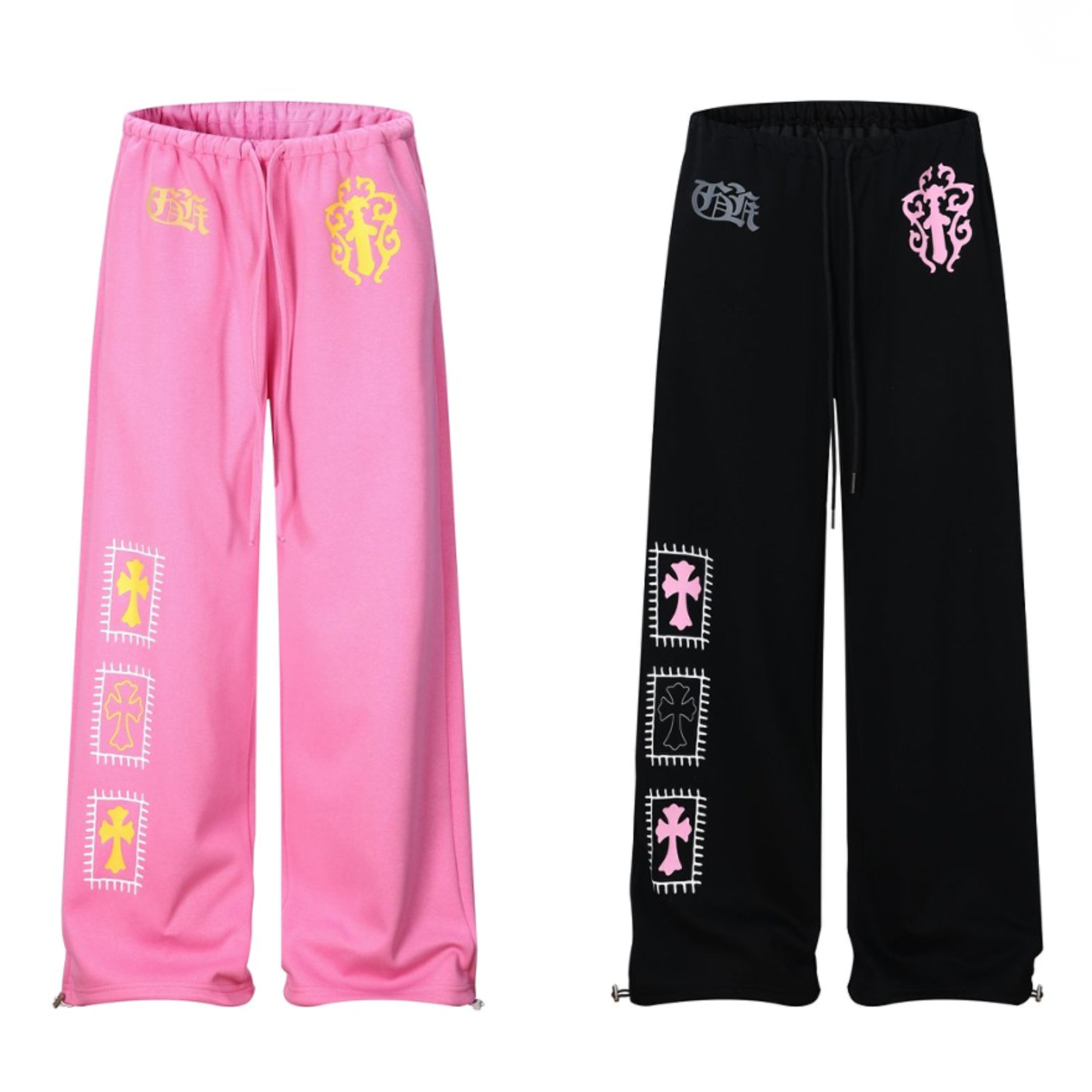 Pink and black wide-leg sweatpants with gold and pink cross graphics and framed patch prints on the leg