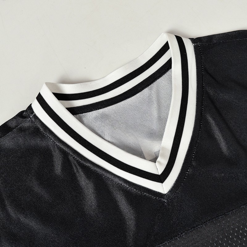 Black football jersey with white striped V-neck collar and textured streetwear varsity styling