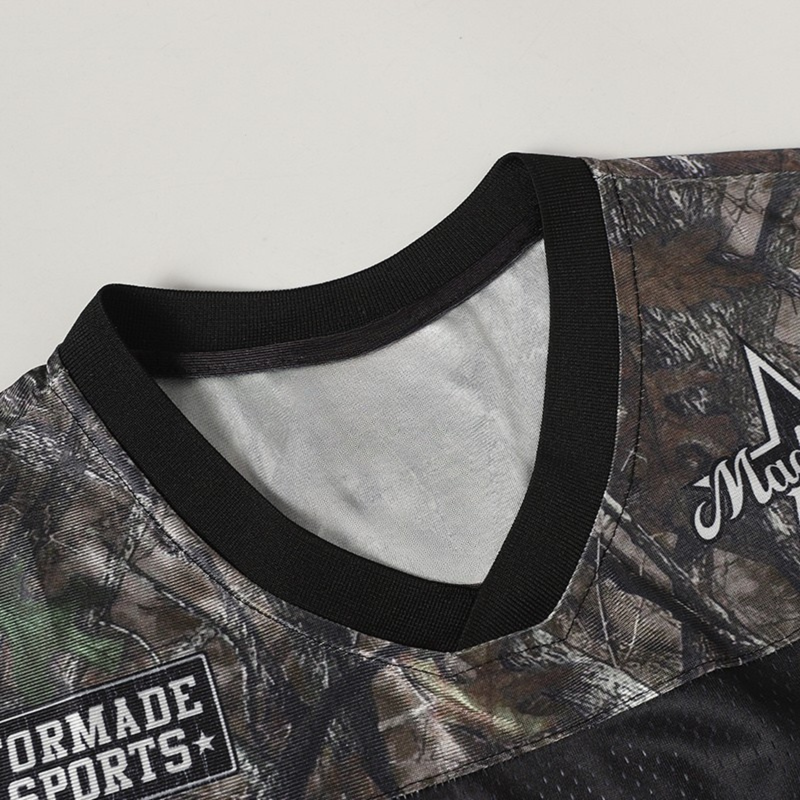 Camo performance football jersey with black ribbed collar and Varsity-style printed chest details