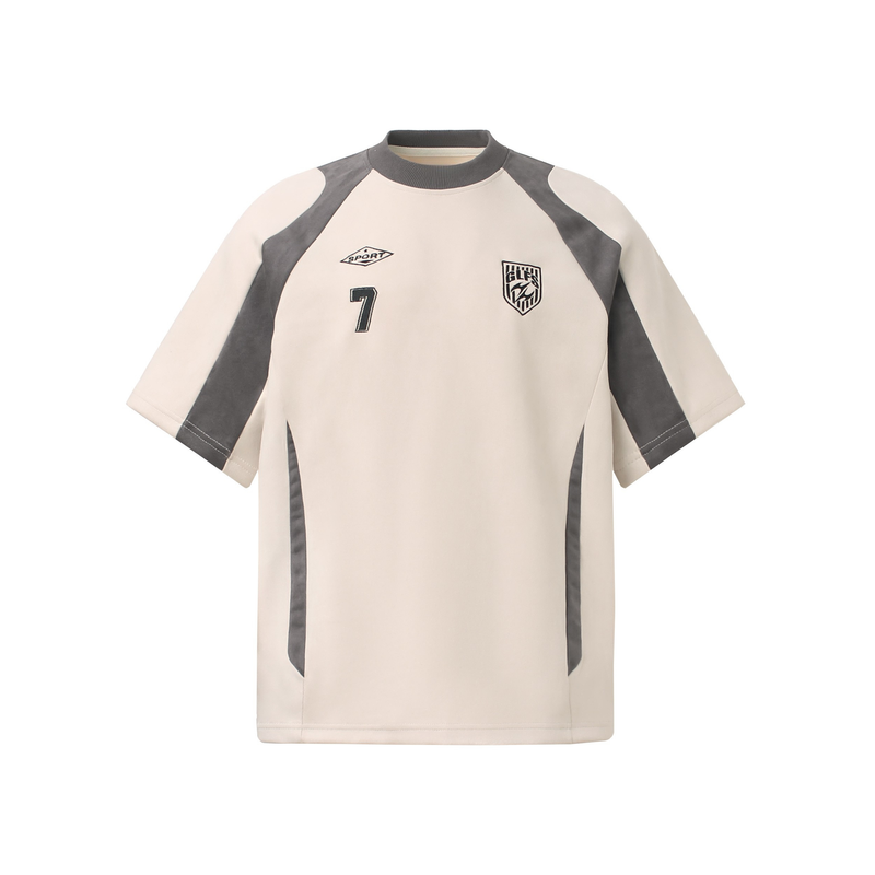 Cream athletic T-shirt with charcoal suede paneling, raglan sleeves, and sporty chest graphics