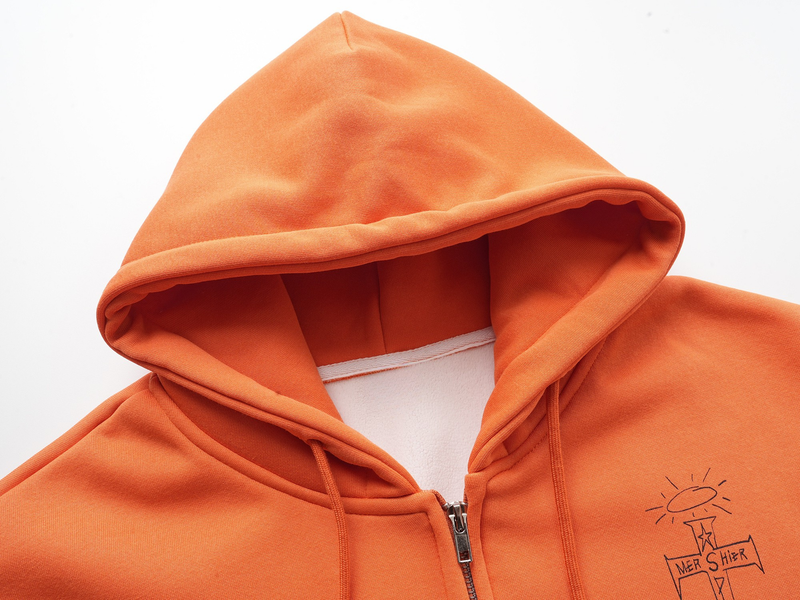 Close-up of orange hoodie hood and zipper at the front neckline