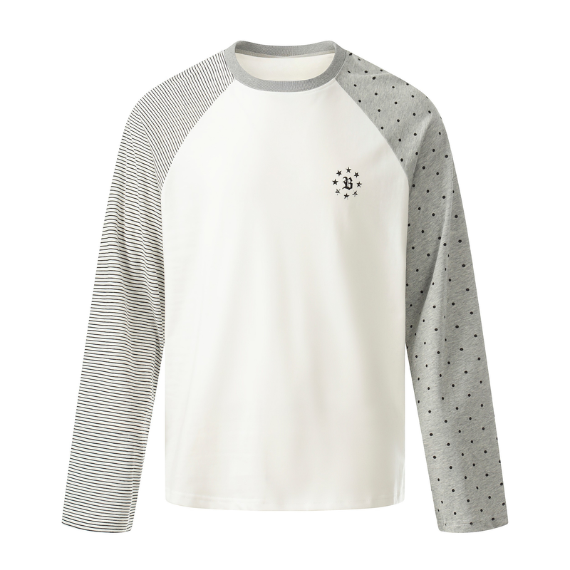 White raglan long sleeve tee with gray striped left sleeve and gray polka dot right sleeve