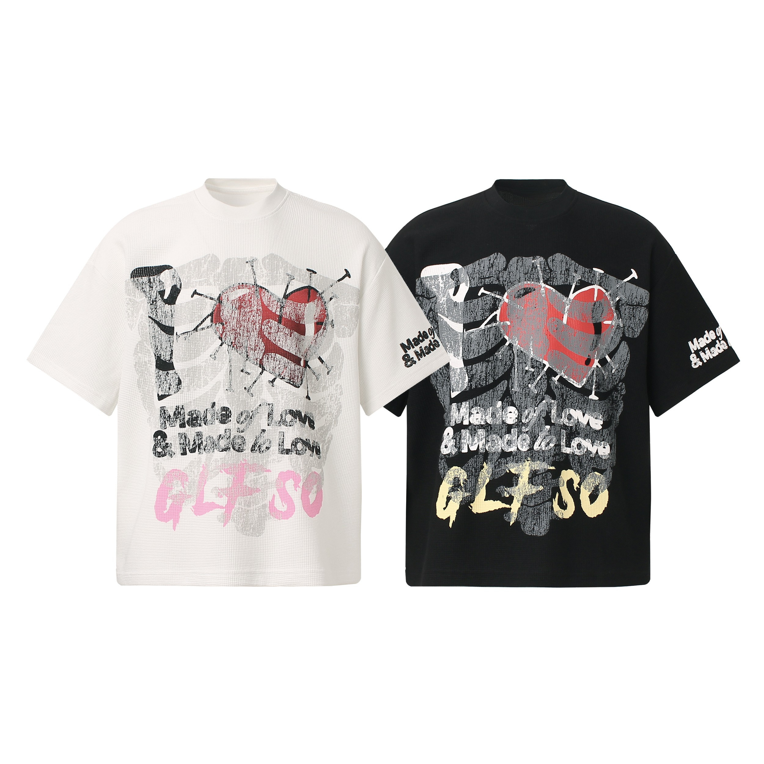 White and black oversized graphic tees with distressed heart-and-nails print and Made of Love typography on the front