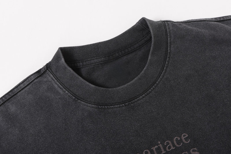 Close-up of the ribbed crew neckline on a black washed long sleeve tee