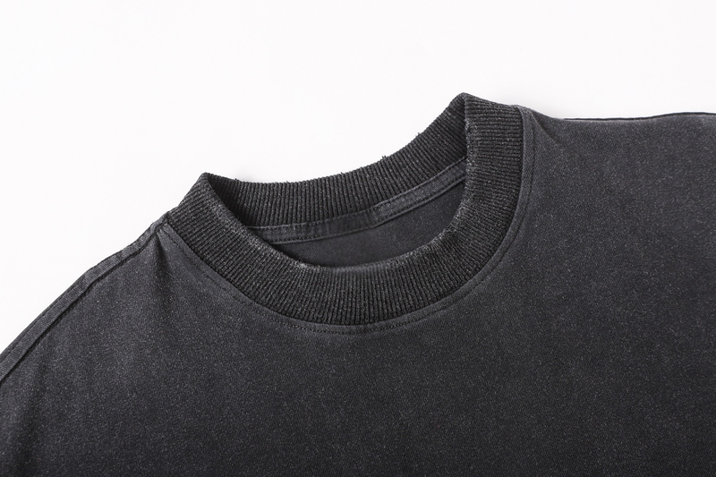 Close-up of black ribbed crew neck and layered collar detail