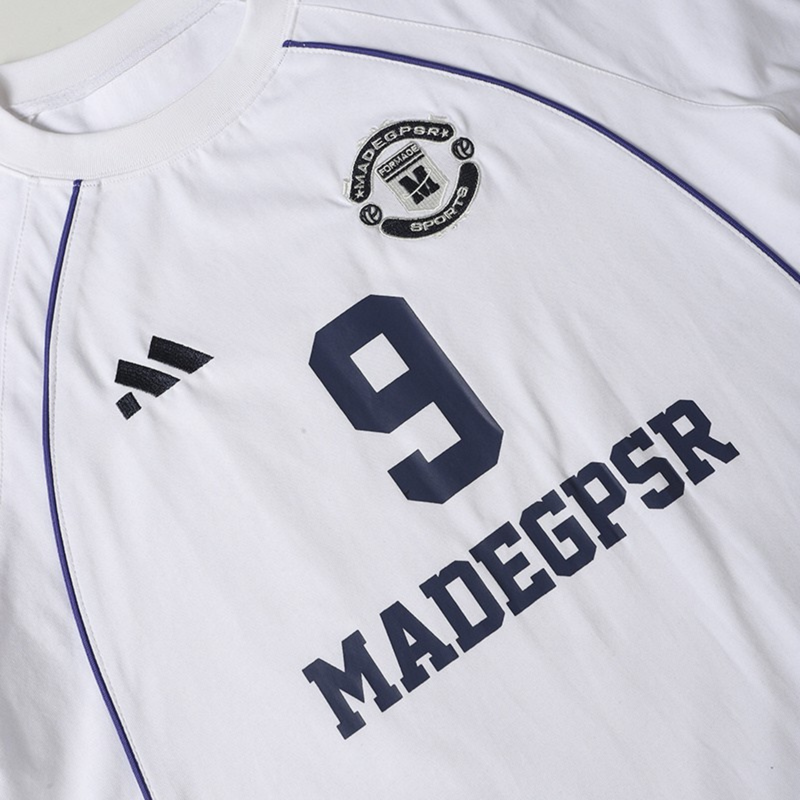 White football jersey T-shirt with navy piping, large number 9, and MADGSR graphic on the front