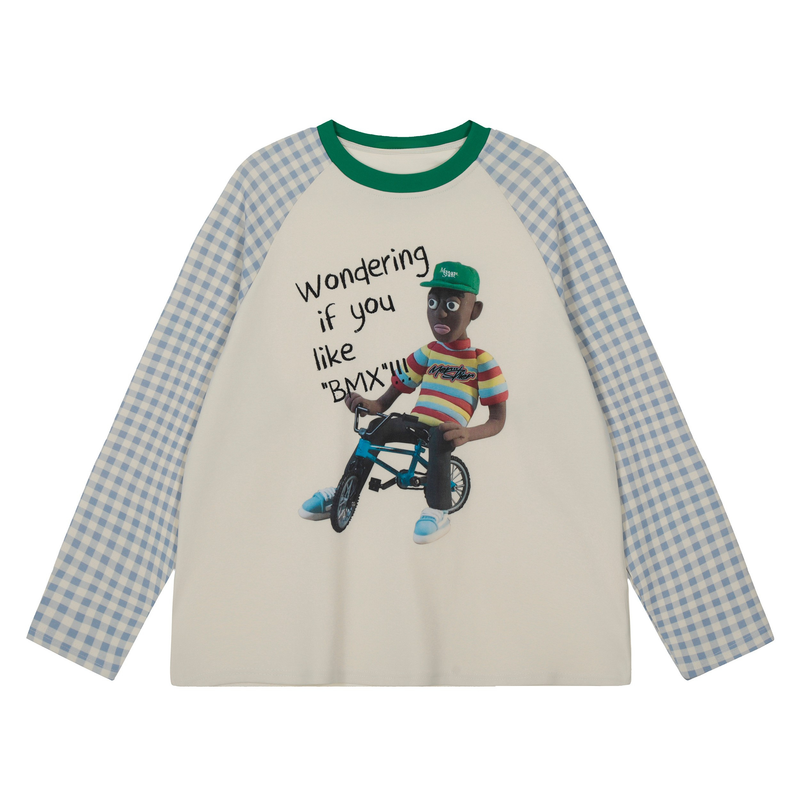 Cream long-sleeve raglan tee with blue gingham sleeves and green collar, graphic front