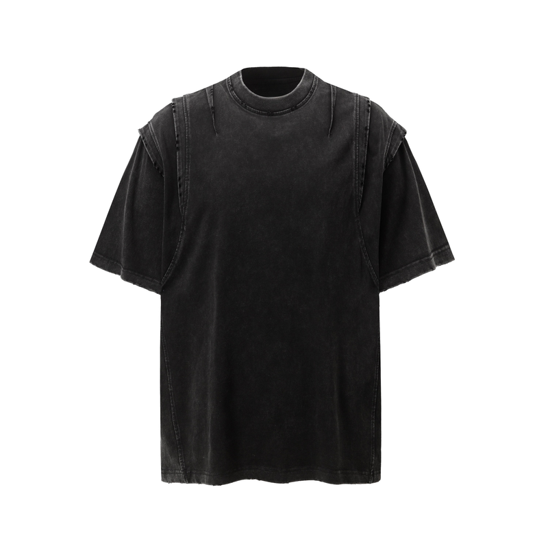 Washed black panel tee with distressed seams and oversized streetwear fit, shown on a white background