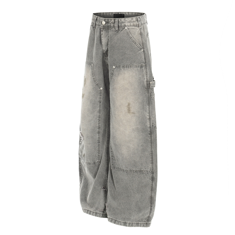 Angled front view of gray distressed carpenter jeans with wide legs and side utility pocket