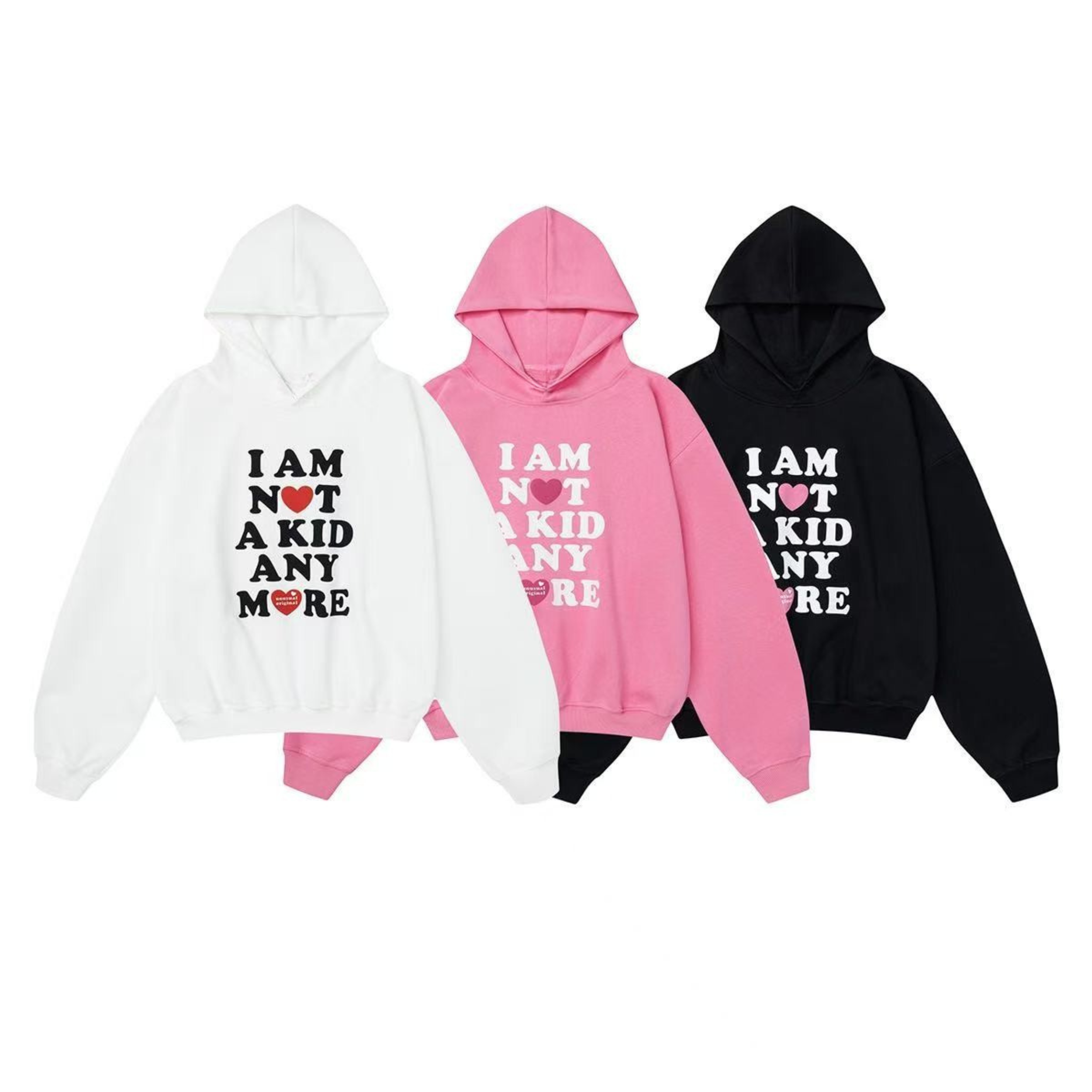 Three oversized graphic pullover hoodies in white, pink, and black with I Am Not A Kid Anymore slogan print