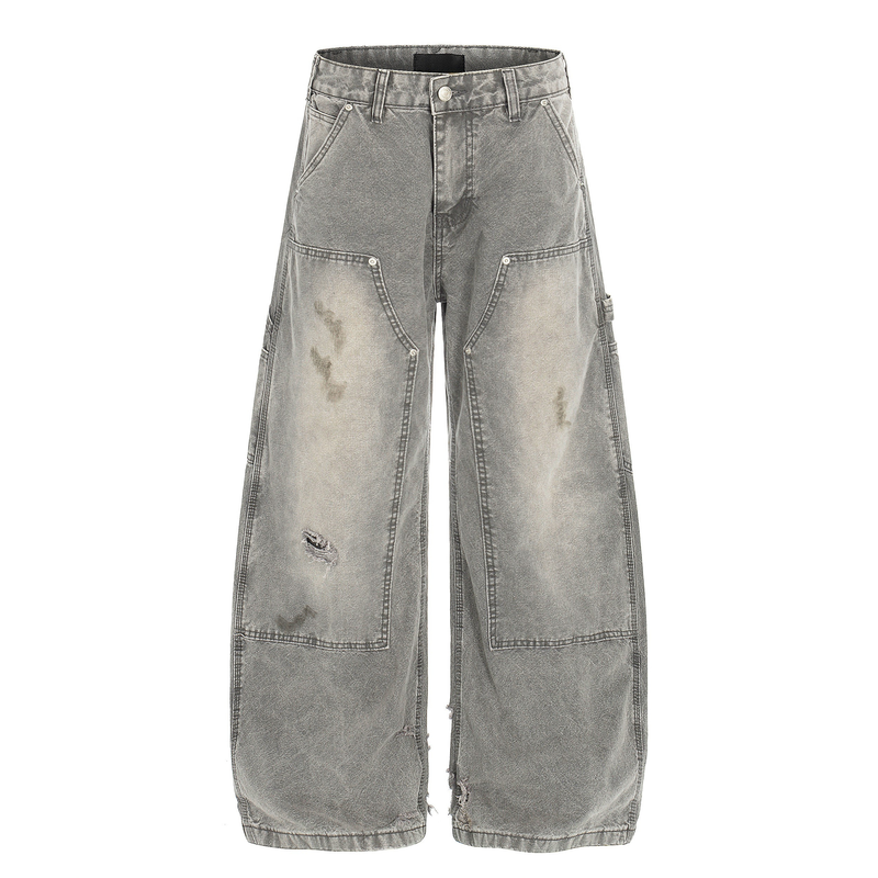 Front view of gray washed distressed wide leg carpenter jeans with knee patches and ripped detail