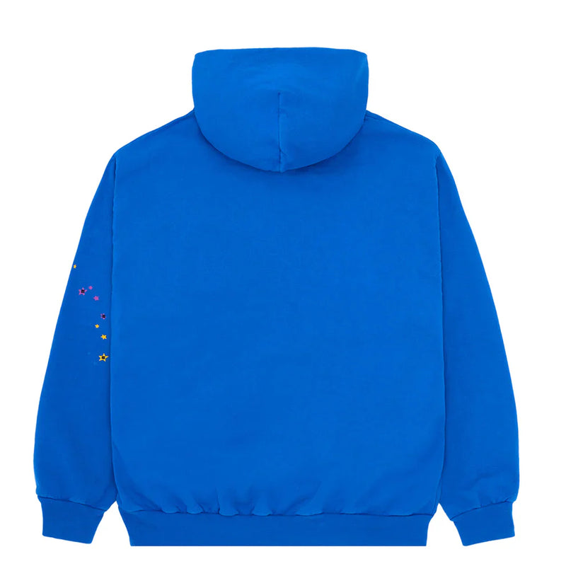 The Sp5der “Hares the Slime” Hoodie in royal blue is shown from the back, crafted from heavyweight (440GSM) cotton fleece, and features a fuzzy spider-web graphic logo with small colorful star accents on the sleeve.