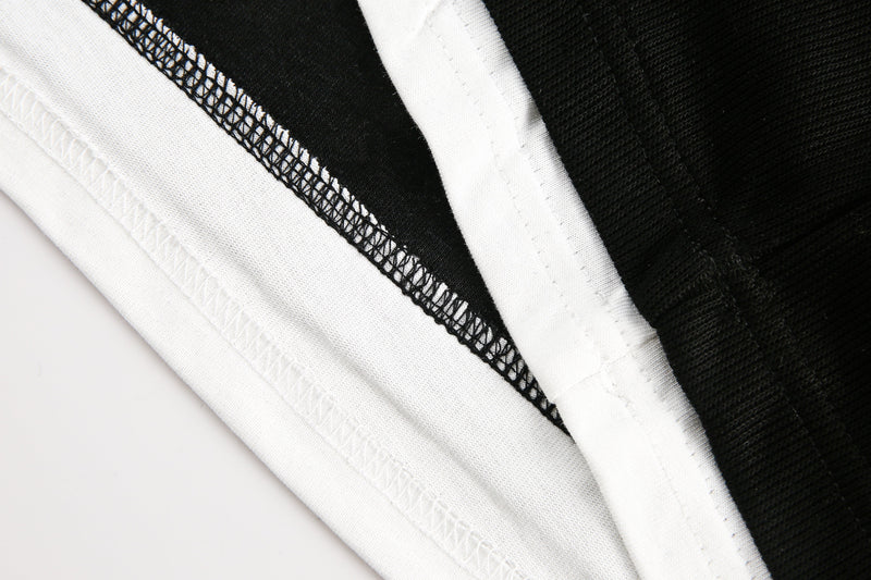 Close-up of black and white hem seam with visible stitching