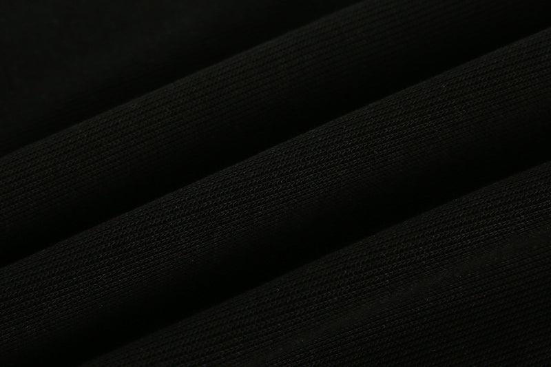Close-up of black mesh-like fabric texture on the sweatshirt